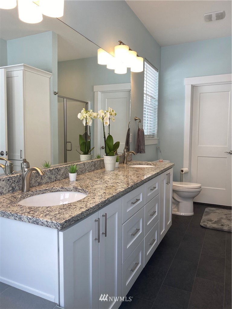 3519 McGee Road Blaine, WA 98230 - Photo 22 of 40 a bathroom with a granite countertop sink and a mirror