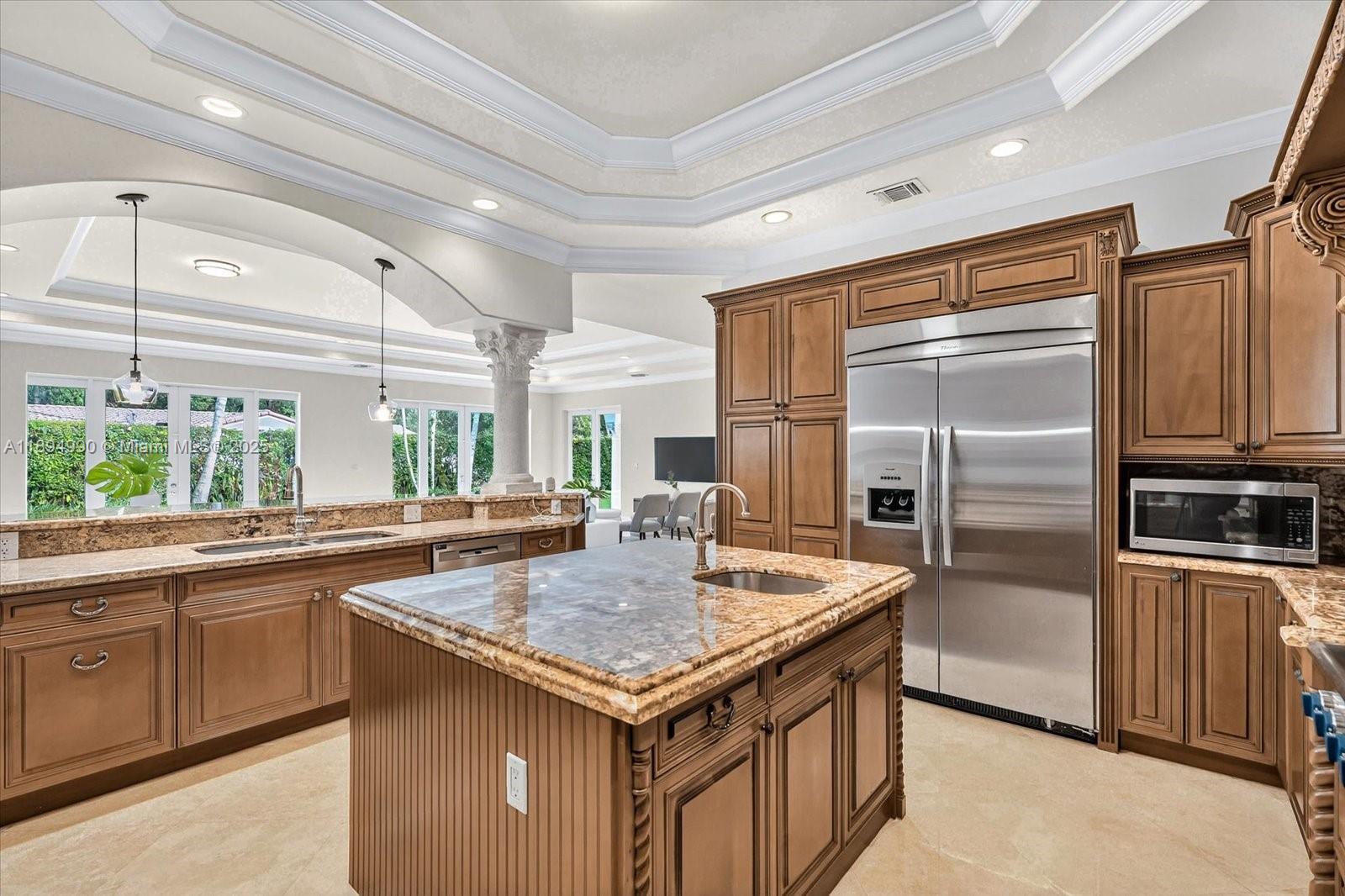 7975 Southwest 52nd Court Miami, FL 33143 - Photo 13 of 26 a kitchen with a refrigerator a sink a stove and cabinets