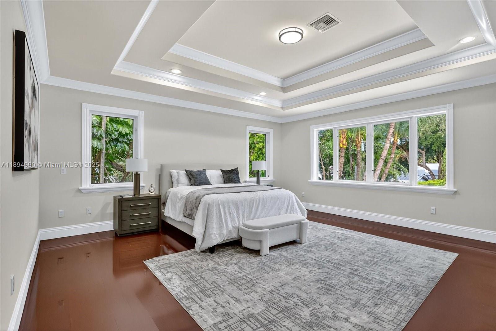 7975 Southwest 52nd Court Miami, FL 33143 - Photo 16 of 26 a spacious bedroom with a bed and wooden floor