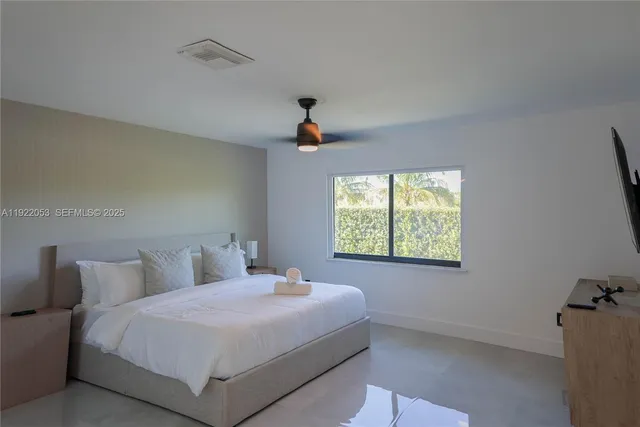 a bedroom with a bed and a window