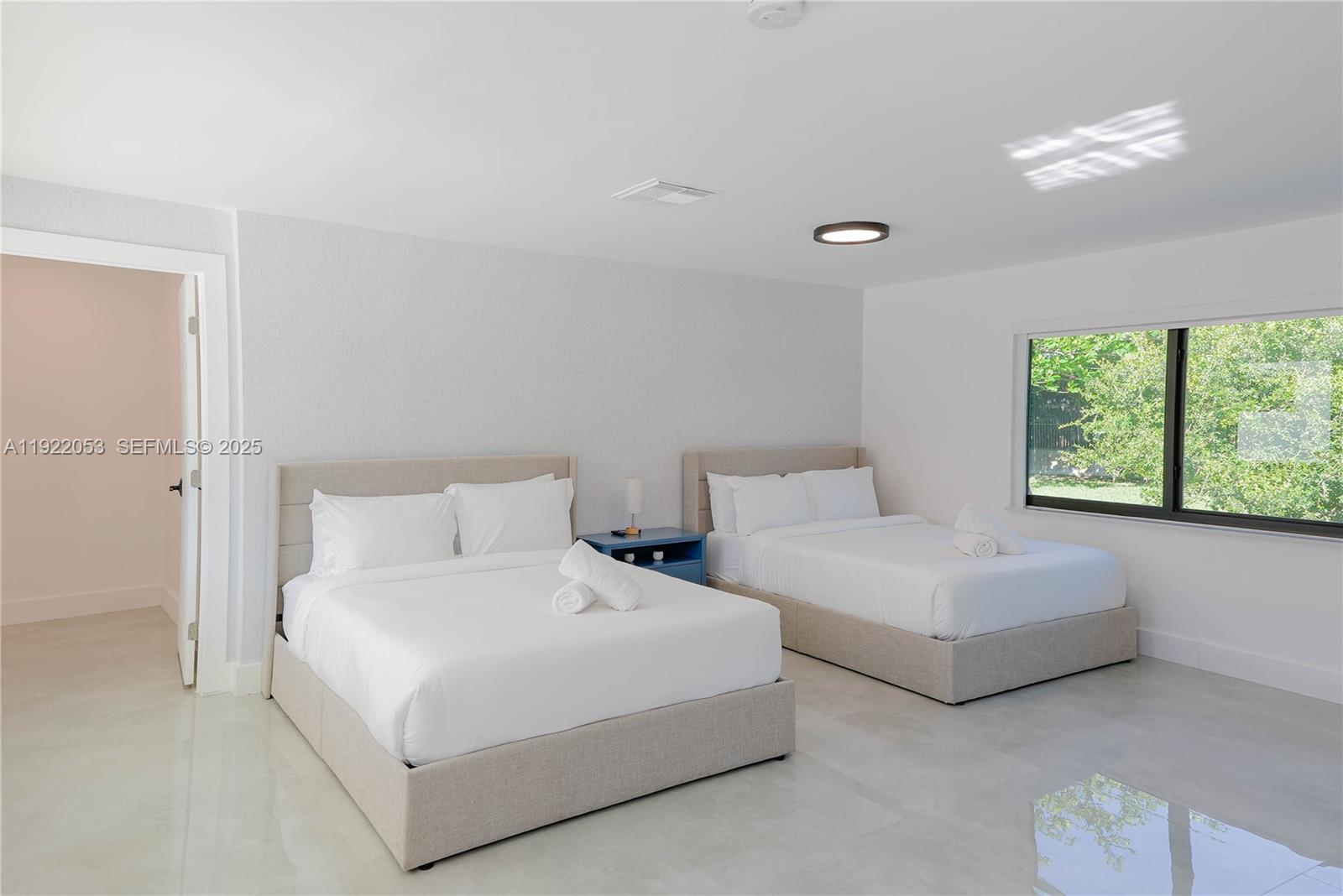 13355 Southwest 207th Avenue Miami, FL 33196 - Photo 15 of 26 a bedroom with two beds and a large window