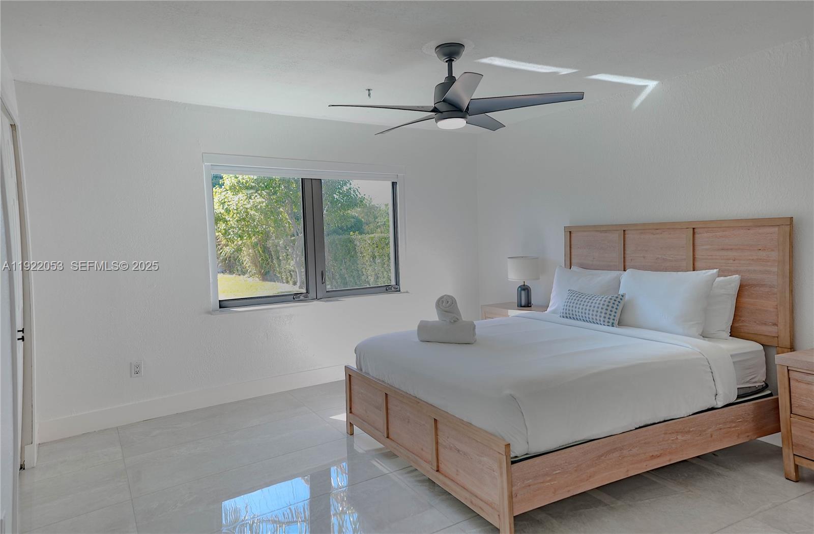 13355 Southwest 207th Avenue Miami, FL 33196 - Photo 18 of 26 a bedroom with a bed and a chandelier