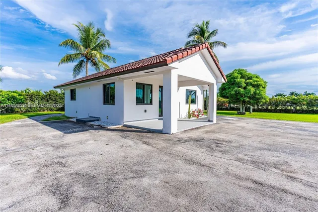 a view of a house with a yard and garage