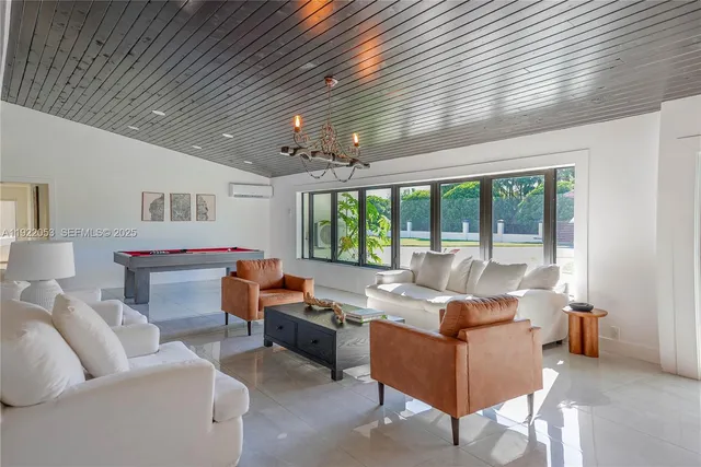 a living room with furniture and large windows