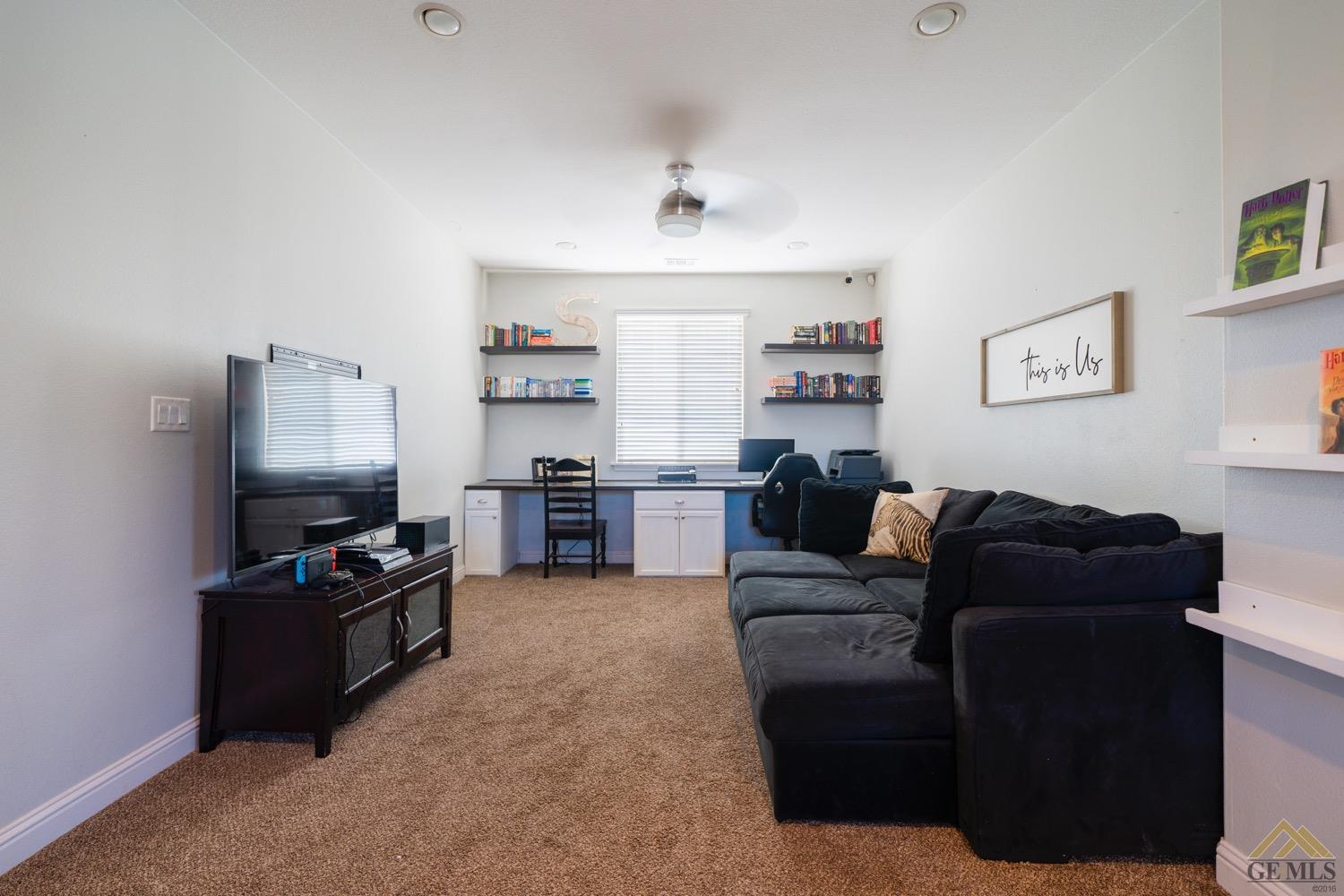 Undisclosed Address Bakersfield, CA 93312 - Photo 18 of 33 a living room with furniture and a flat screen tv