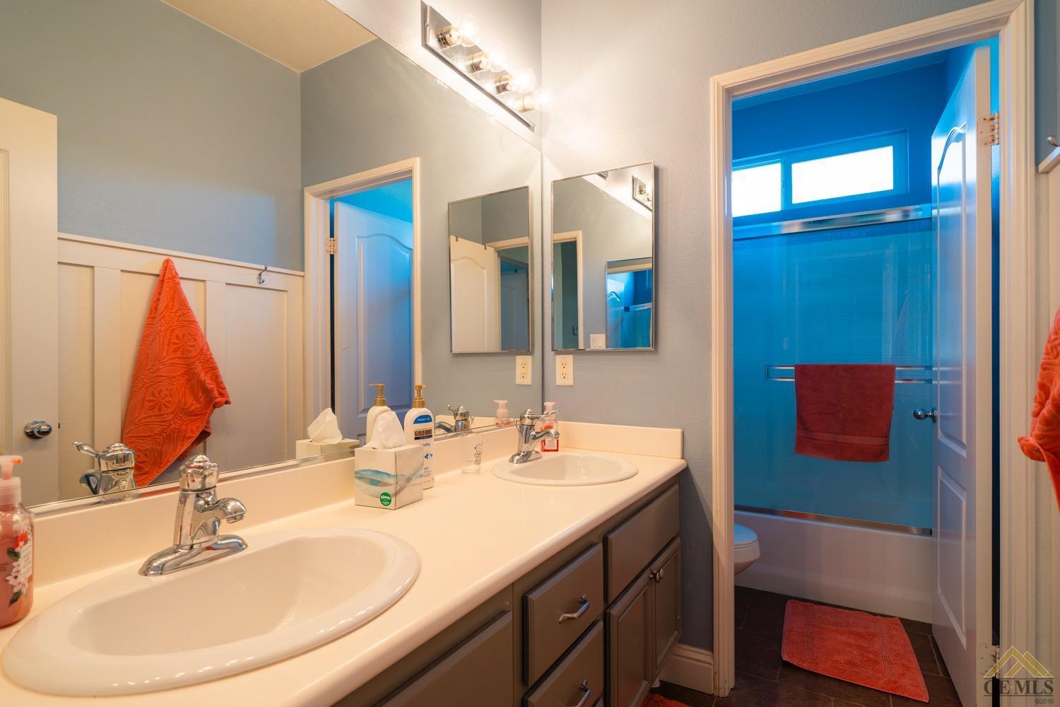 Undisclosed Address Bakersfield, CA 93312 - Photo 20 of 33 a bathroom with a double vanity sink and a mirror