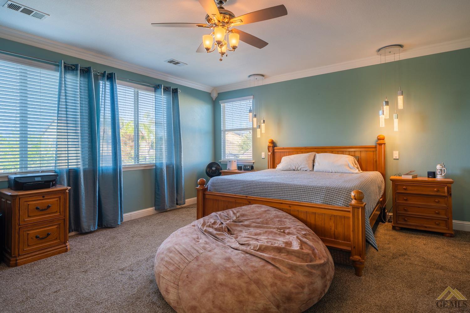 Undisclosed Address Bakersfield, CA 93312 - Photo 24 of 33 a bedroom with a bed and a chandelier