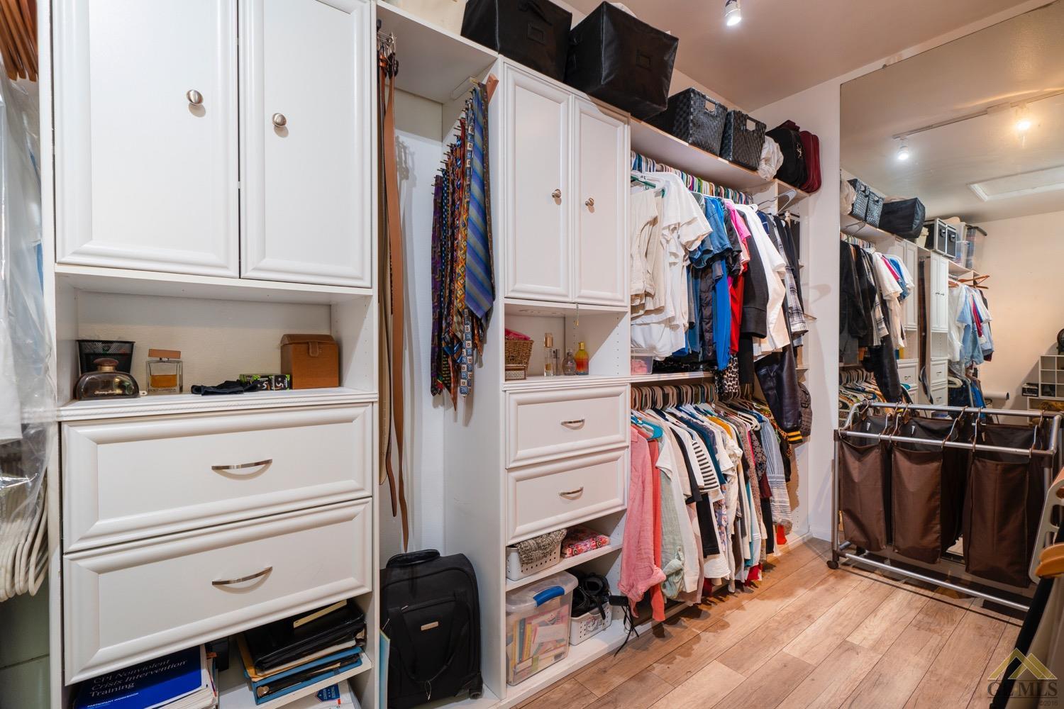 Undisclosed Address Bakersfield, CA 93312 - Photo 27 of 33 a view of walk in closet with clothes and shoes