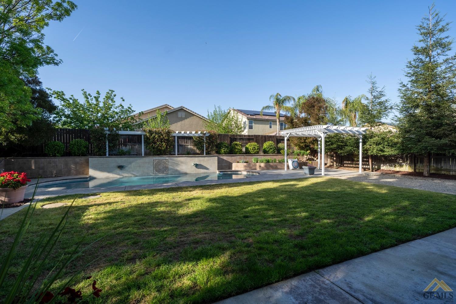 Undisclosed Address Bakersfield, CA 93312 - Photo 28 of 33 a swimming pool view with a seating space and a garden view