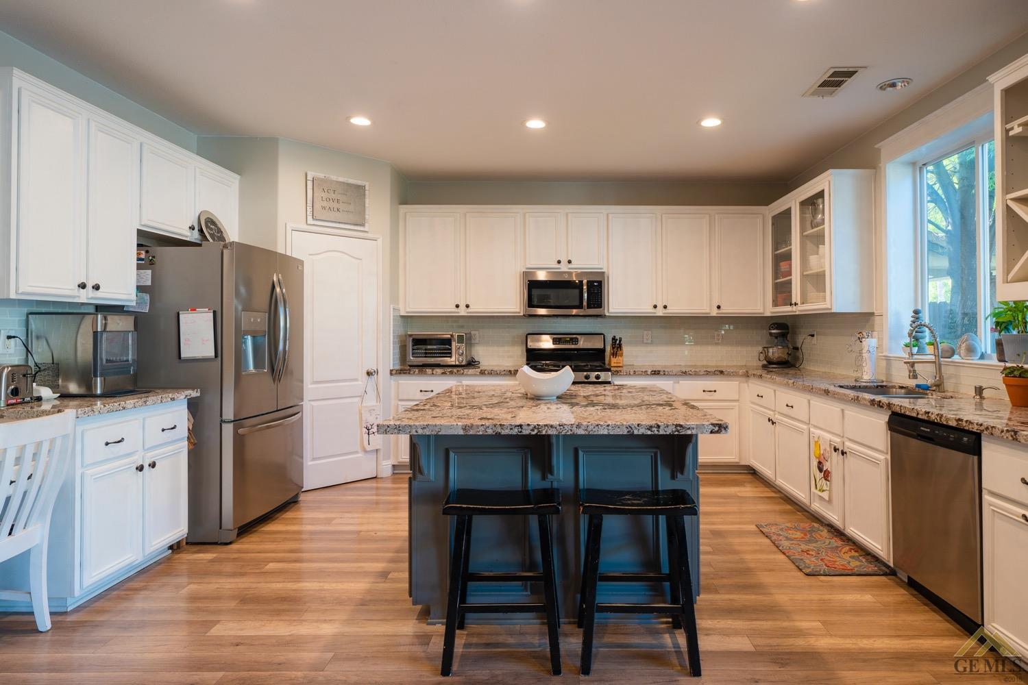 Undisclosed Address Bakersfield, CA 93312 - Photo 9 of 33 a kitchen with kitchen island granite countertop wooden cabinets and stainless steel appliances