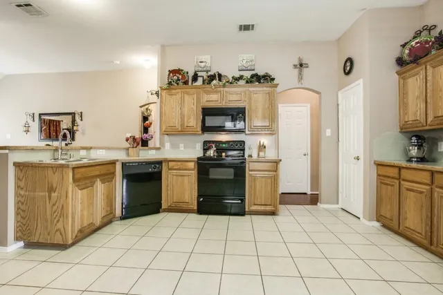 a kitchen with a stove top oven and cabinets