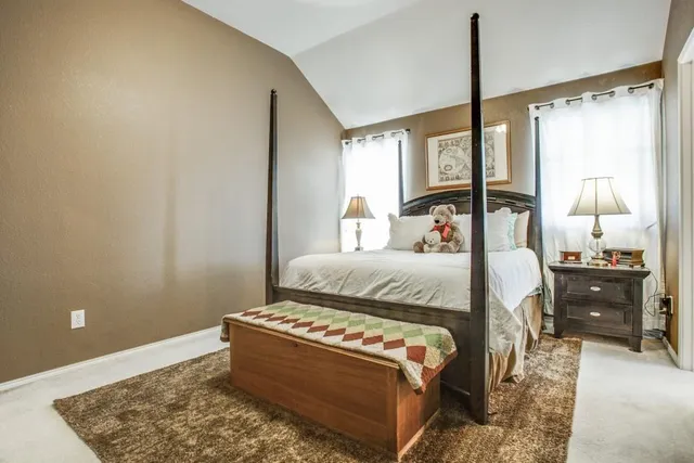 a bedroom with a bed and window