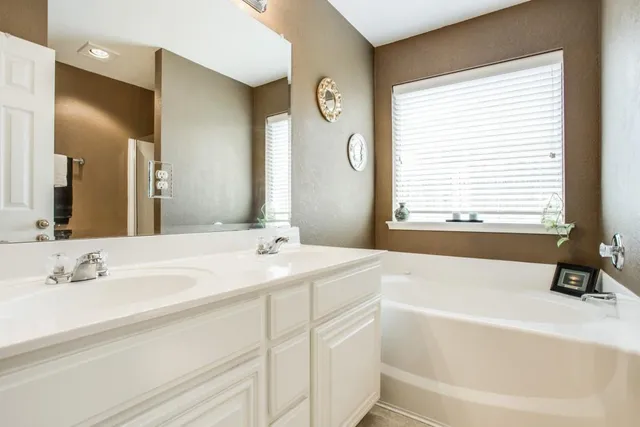 a bathroom with a bathtub and a sink