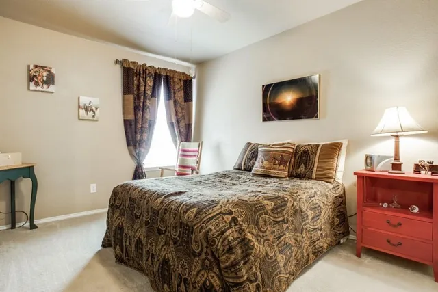 a bedroom with a bed and a lamp