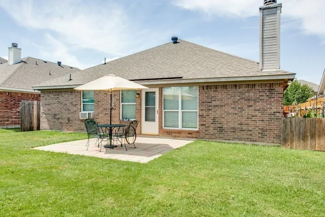 a view of a patio with a table and chairs