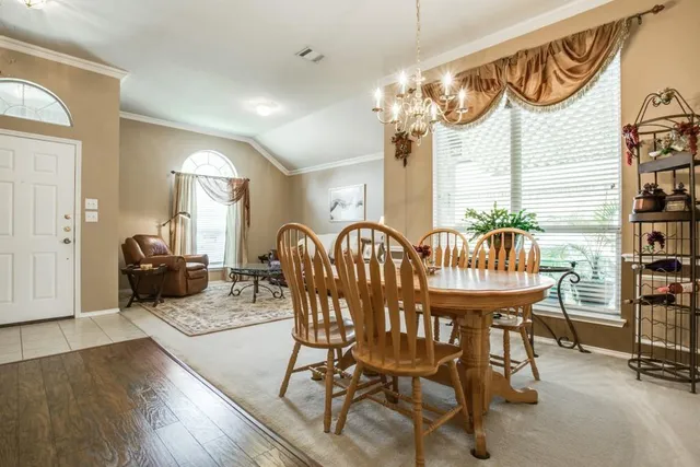 a dinning area with furniture and wooden floor