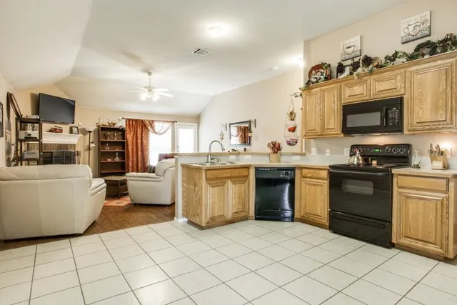 a kitchen with a stove a sink and a refrigerator