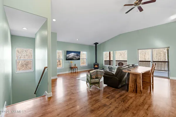 a living room with furniture a wooden floor and a large window