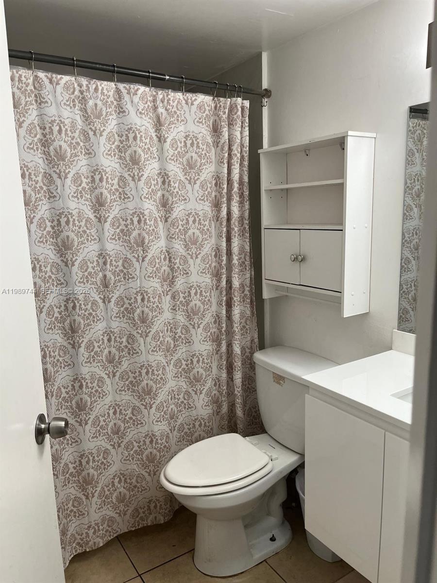 8761 Wiles Road, Unit 206 Coral Springs, FL 33067 - Photo 14 of 16 a bathroom with a toilet and a shower