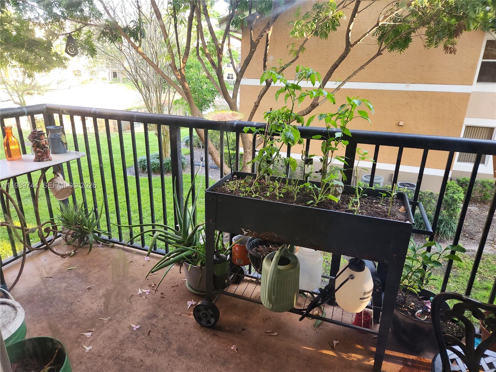 8761 Wiles Road, Unit 206 Coral Springs, FL 33067 - Photo 2 of 16 a view of a porch with a table and chairs