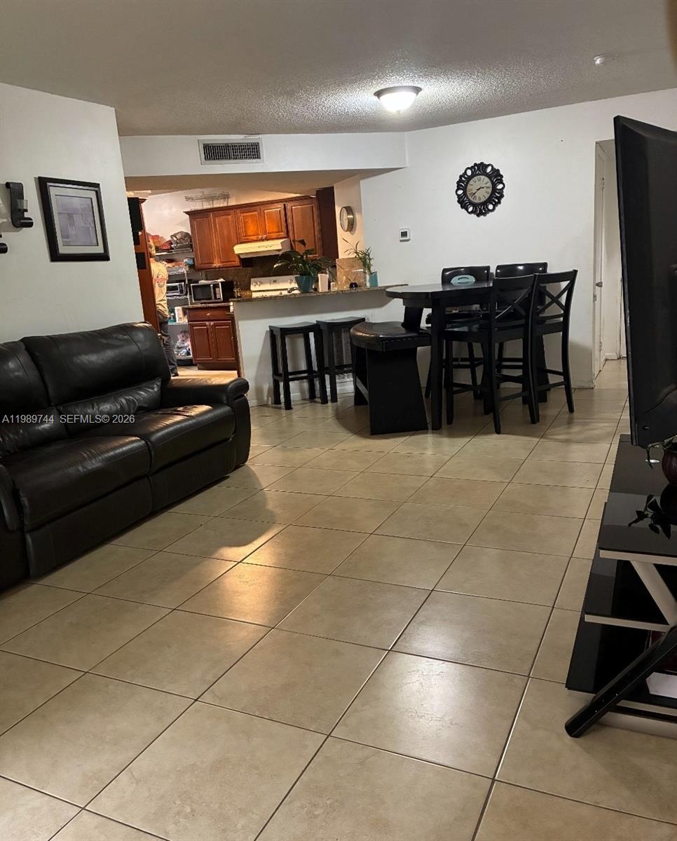 8761 Wiles Road, Unit 206 Coral Springs, FL 33067 - Photo 4 of 16 a large dining space with furniture