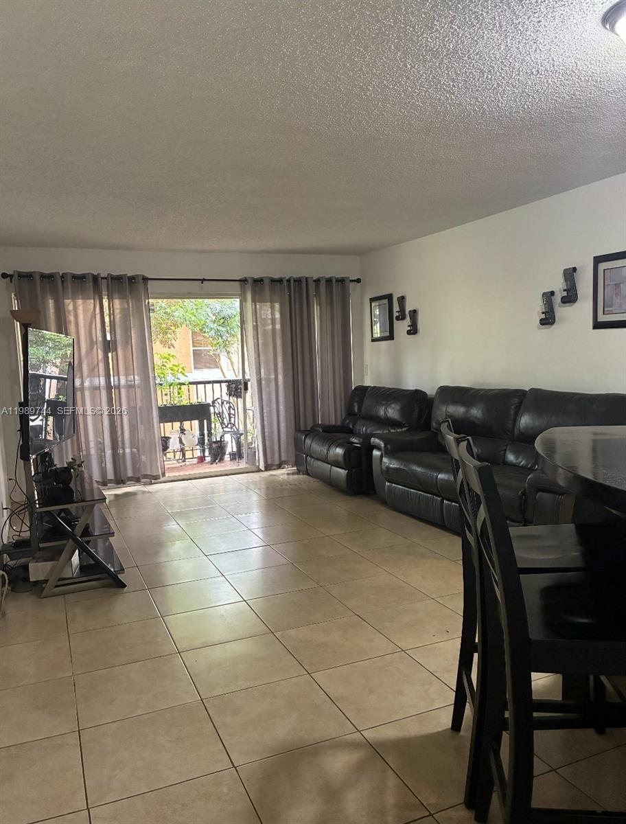 8761 Wiles Road, Unit 206 Coral Springs, FL 33067 - Photo 6 of 16 a view of a livingroom with furniture and windows