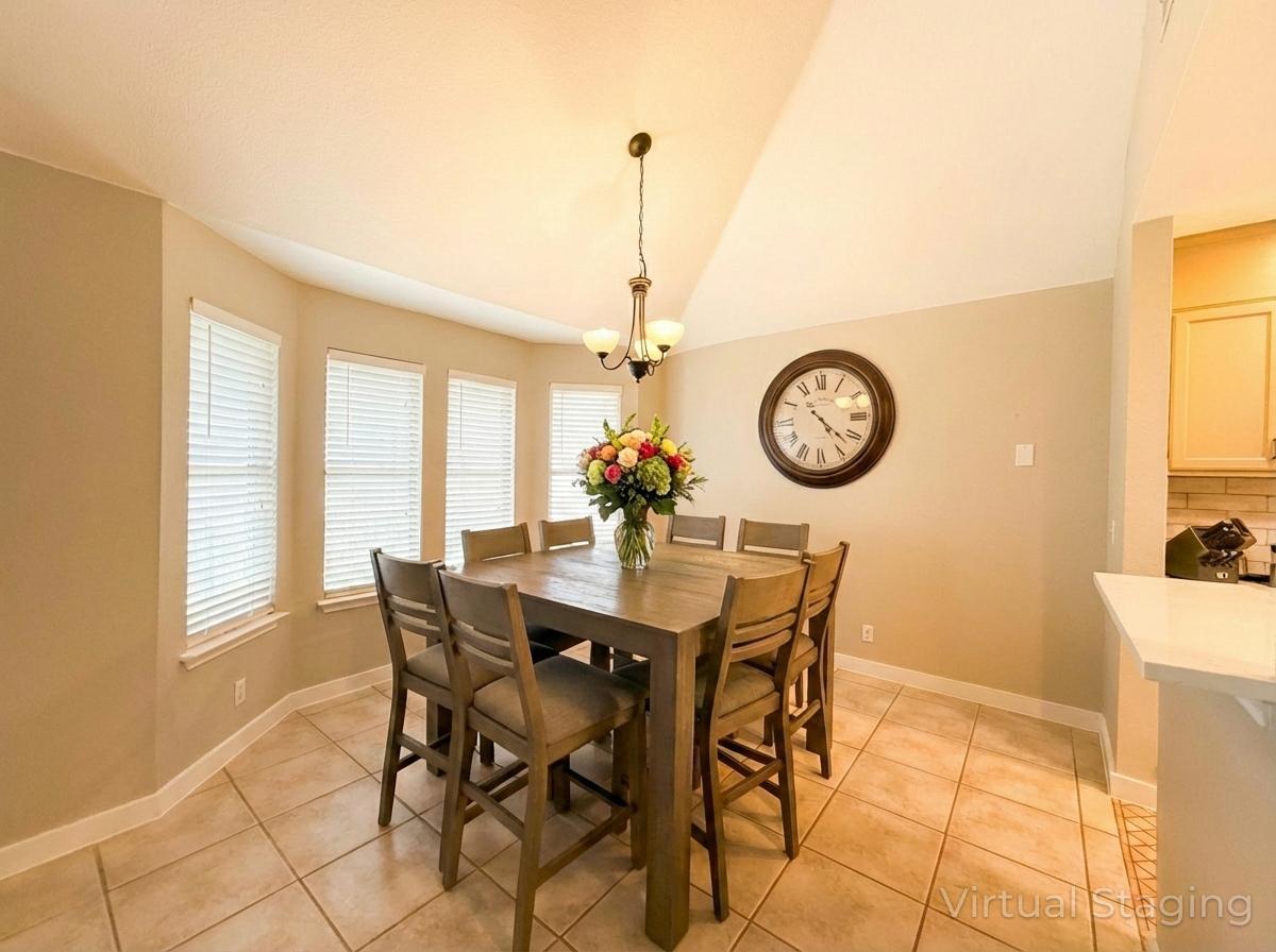 1607 Rio Bravo Loop Leander, TX 78641 - Photo 15 of 31 a dining room with a table and a clock