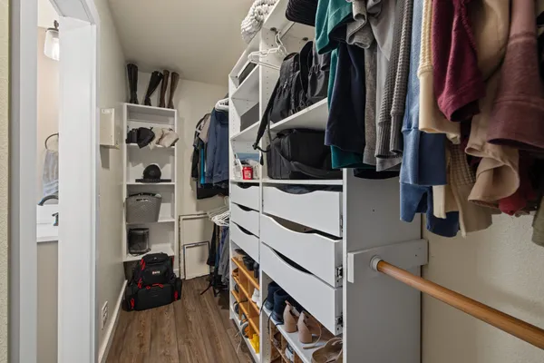 an empty room with a ceiling fan and windows
