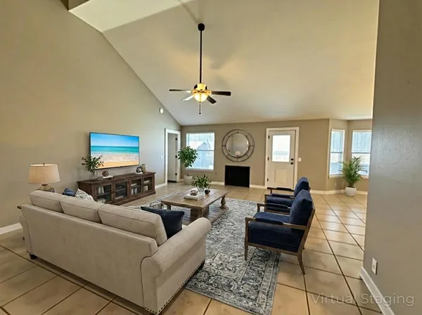 a living room with furniture a mirror and a window