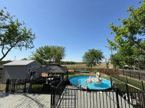 a view of a chairs and table on the roof deck