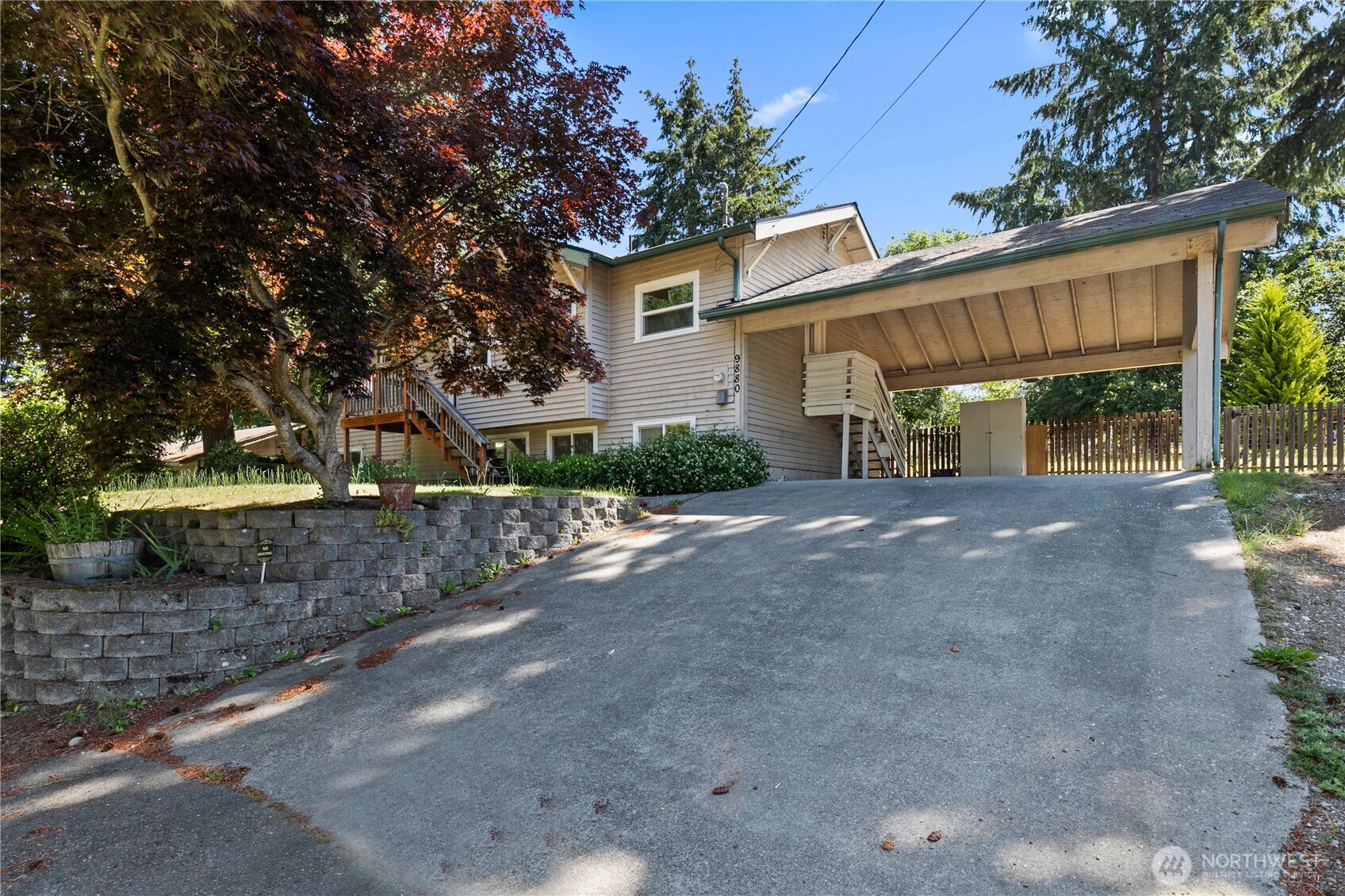 9880 Fredrickson Road Northwest Bremerton, WA 98311 - Photo 2 of 28 a front view of a house with a yard and garage