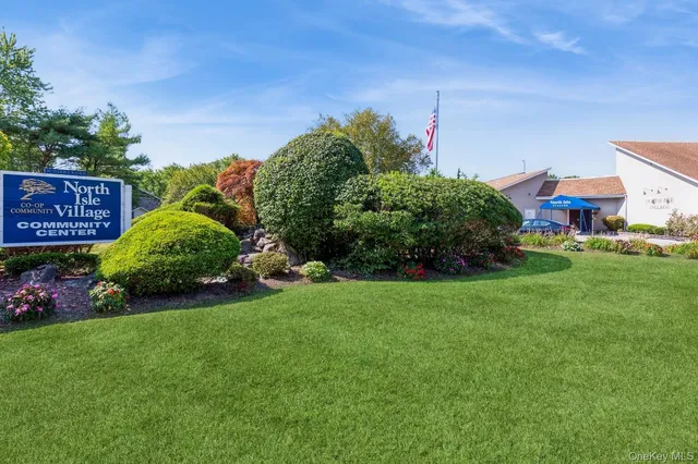 a room with wooden floor pool table and windows