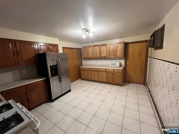 a kitchen with stainless steel appliances a refrigerator and a stove
