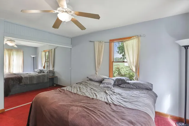 a bedroom with a large bed and a chandelier
