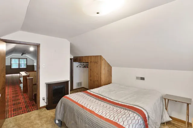 a bedroom with a bed and a television