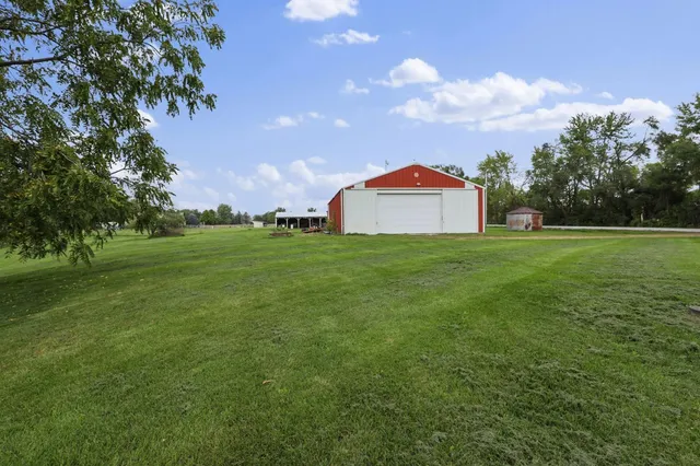 a view of a green field with trees in the background
