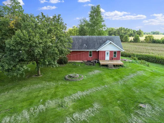 a view of a house with a big yard and large trees