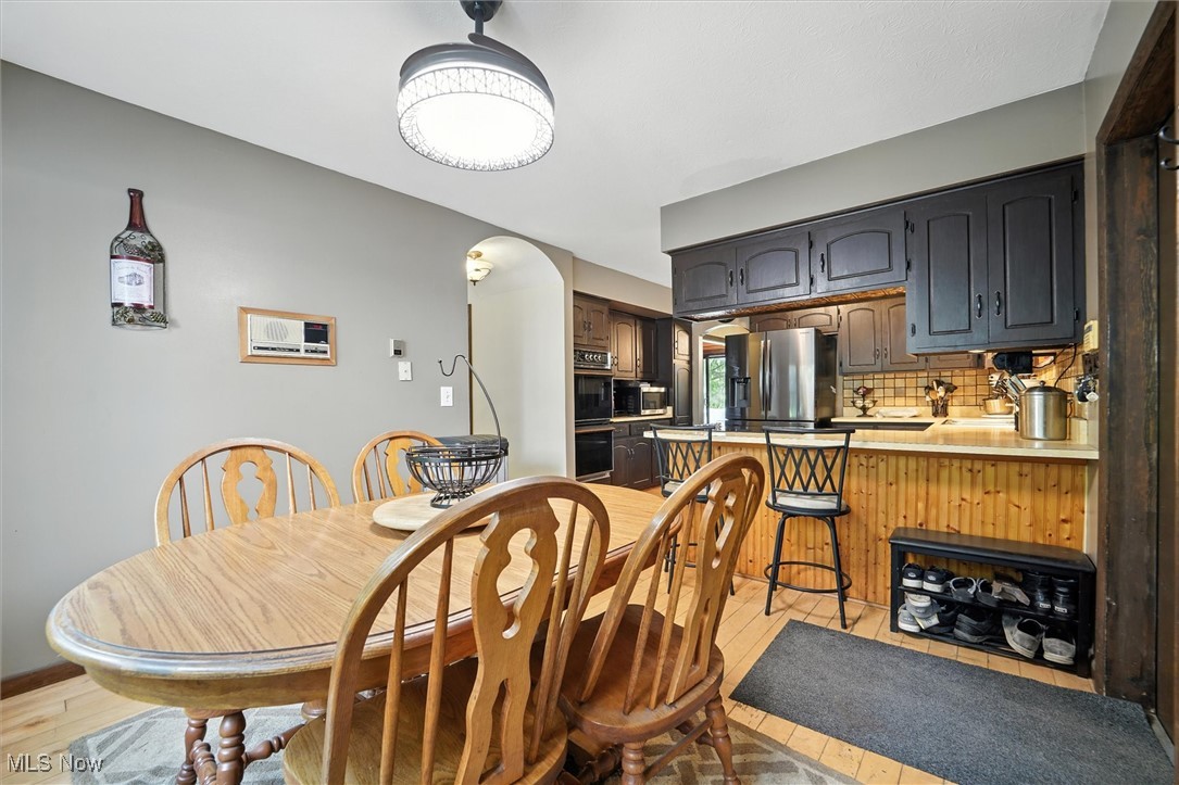 12120 Caves Road Chesterland, OH 44026 - Photo 16 of 50 Dining room with arched walkways and light wood-style floors