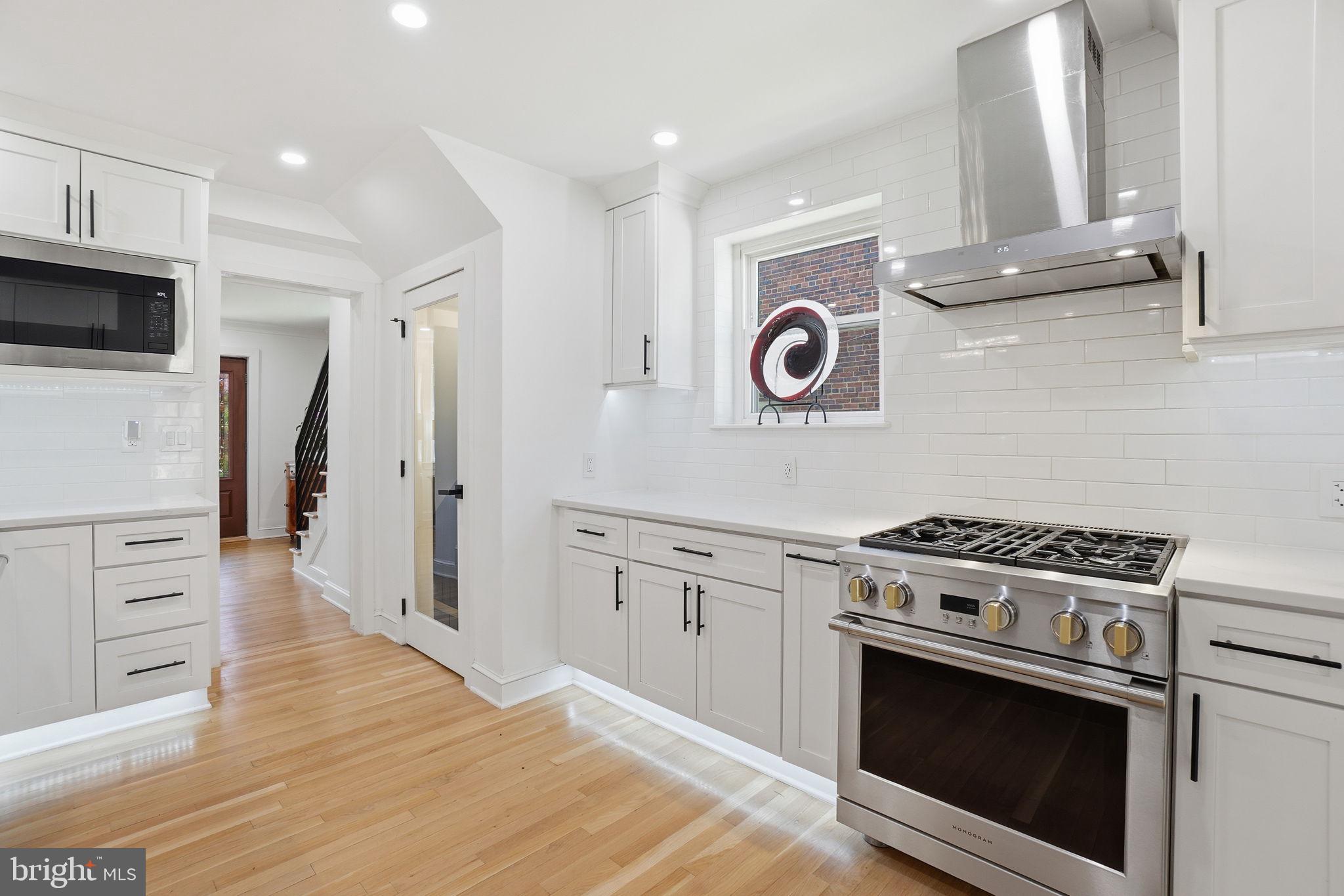 3327 Legation Street Northwest Washington, DC 20015 - Photo 14 of 36 a kitchen with a stove top oven and cabinets