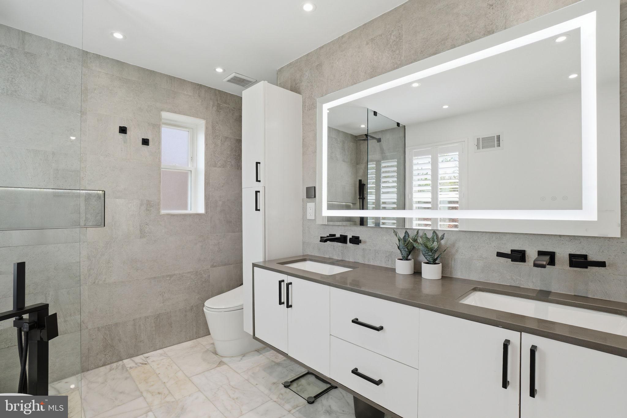 3327 Legation Street Northwest Washington, DC 20015 - Photo 21 of 36 a bathroom with a double vanity sink mirror and double