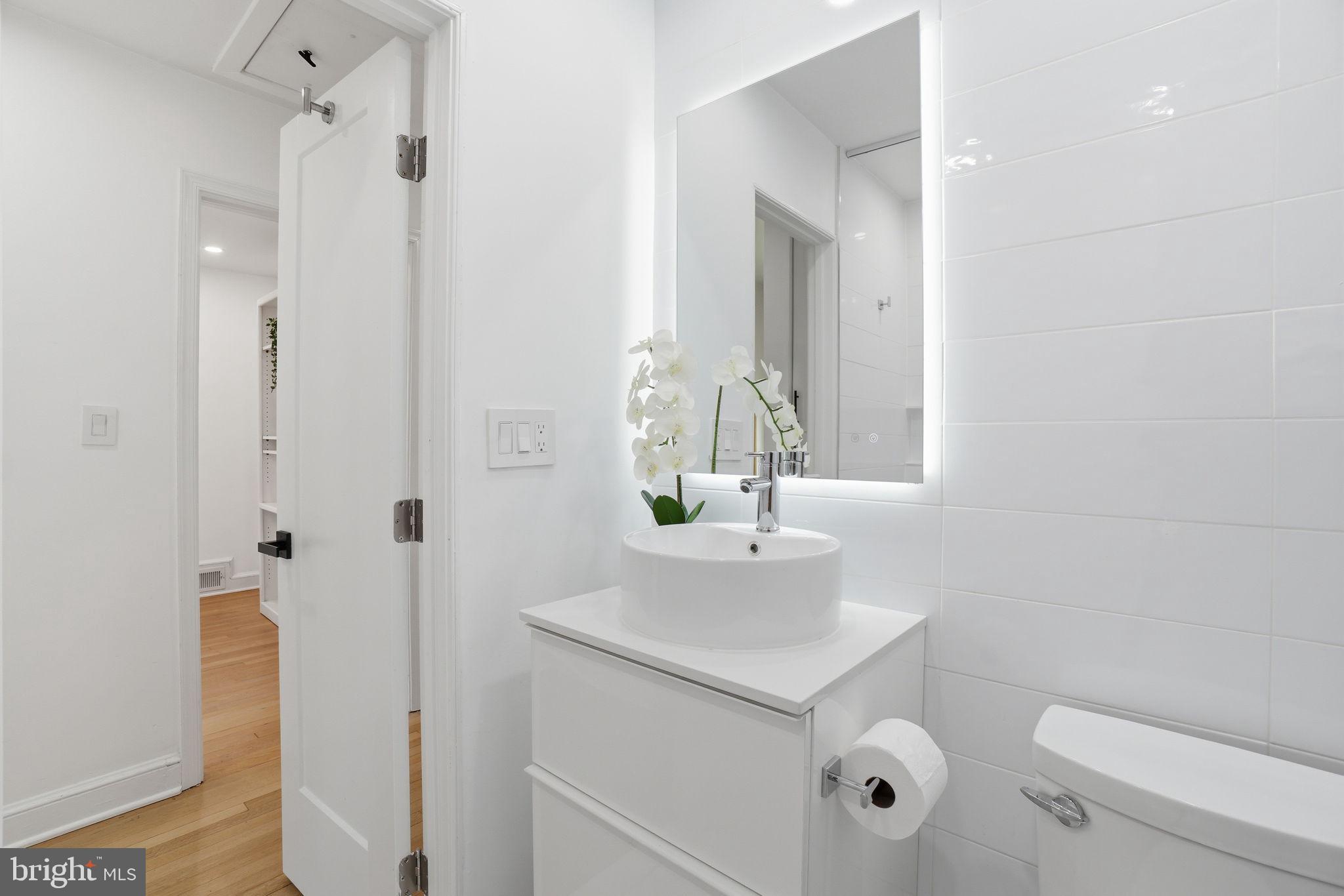 3327 Legation Street Northwest Washington, DC 20015 - Photo 26 of 36 a bathroom with a sink toilet and shower