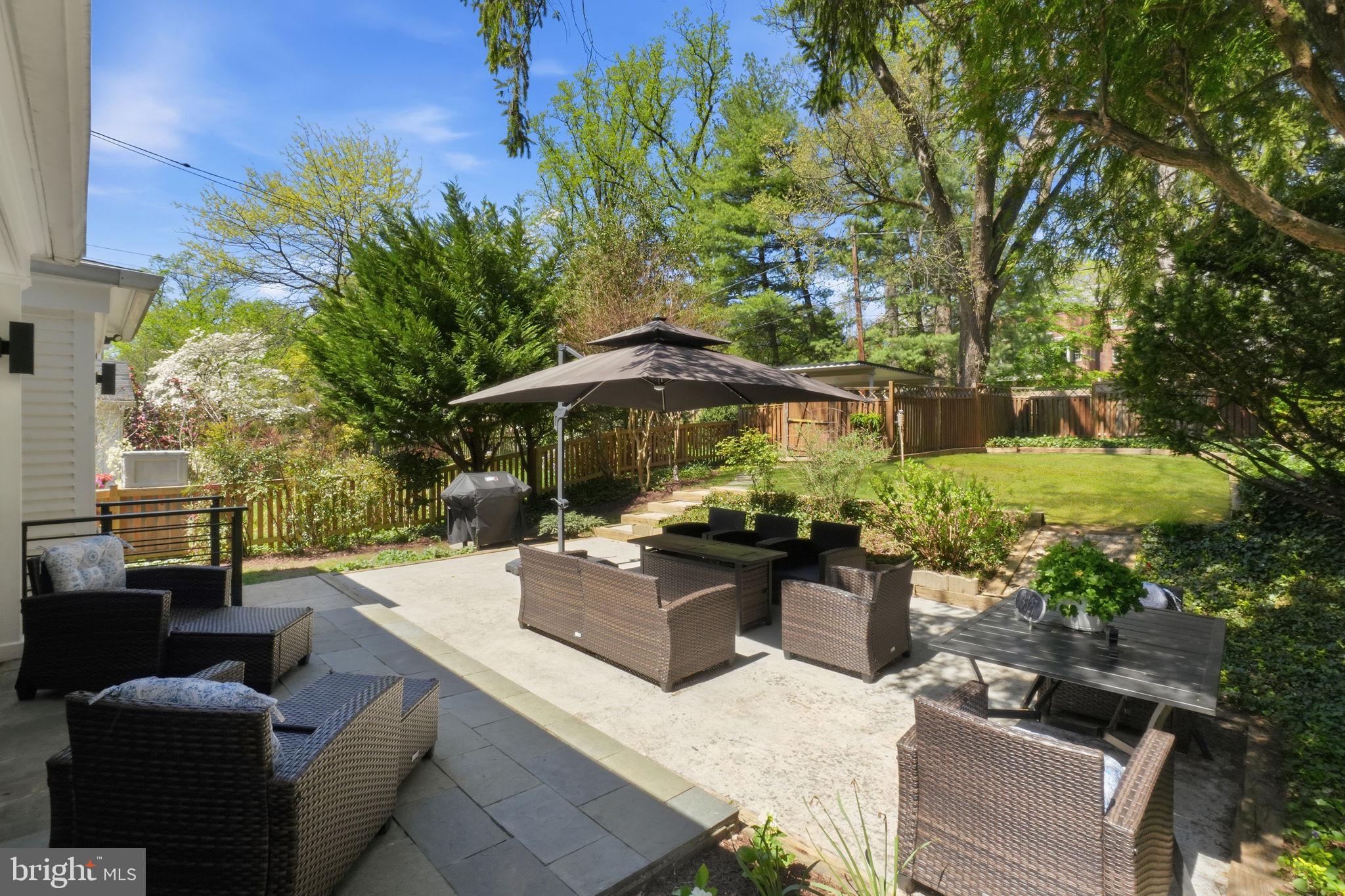 3327 Legation Street Northwest Washington, DC 20015 - Photo 33 of 36 a view of backyard with seating space and trees in the background