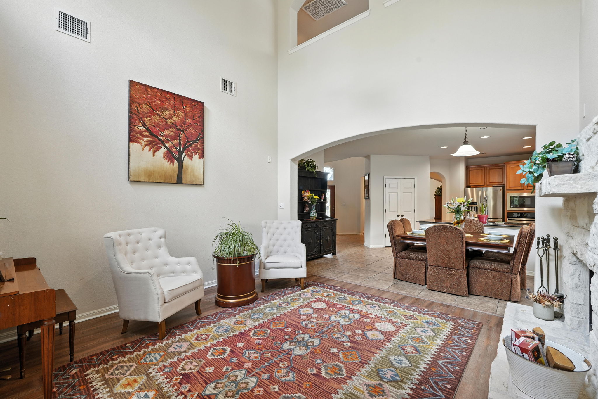 1802 Misty Ridge Leander, TX 78641 - Photo 21 of 39 Foyer entrance with arched walkways, light wood finished floors, a high ceiling, and a fireplace