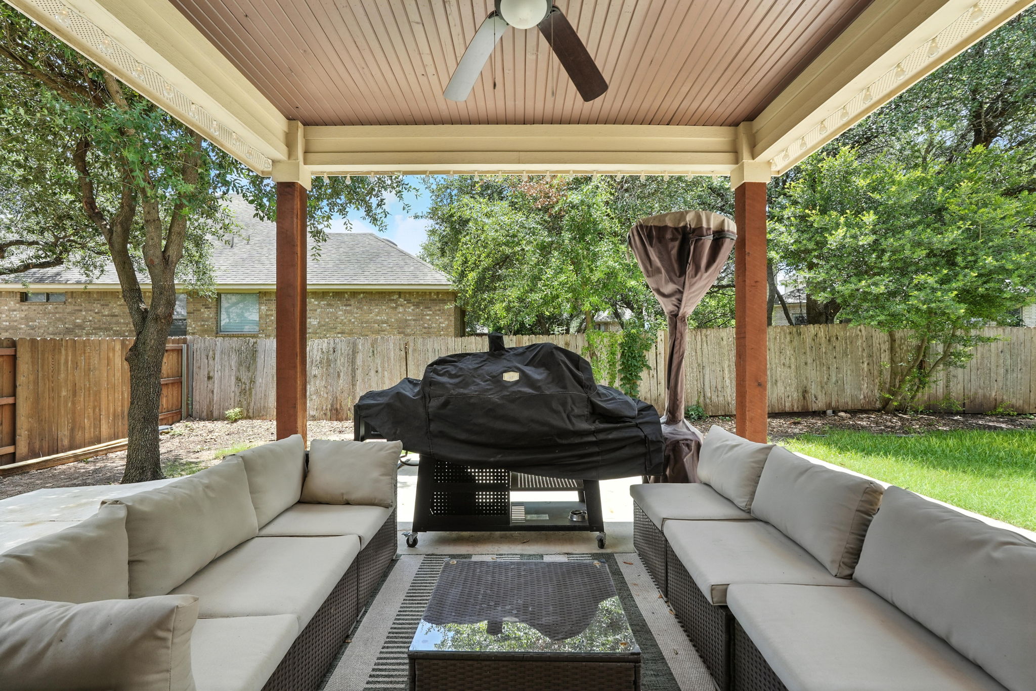 1802 Misty Ridge Leander, TX 78641 - Photo 23 of 39 Fenced backyard with a ceiling fan, a patio area, an outdoor living space, and grilling area