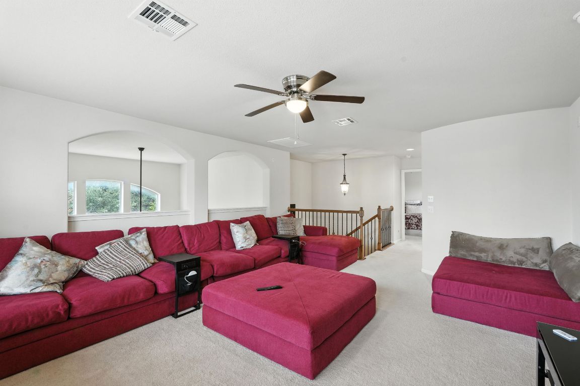 1802 Misty Ridge Leander, TX 78641 - Photo 27 of 39 a living room with furniture a ceiling fan and a rug