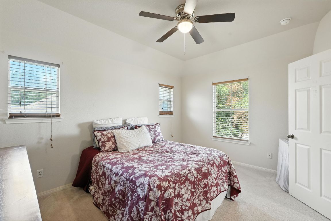 1802 Misty Ridge Leander, TX 78641 - Photo 29 of 39 a bedroom with a large bed and a window
