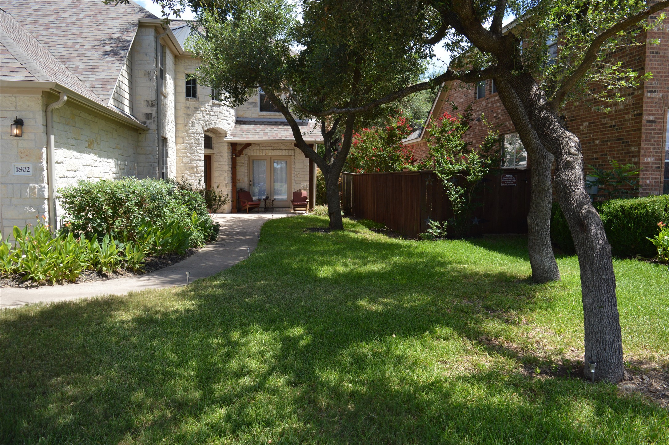 1802 Misty Ridge Leander, TX 78641 - Photo 3 of 39 View of yard with french doors and a garage