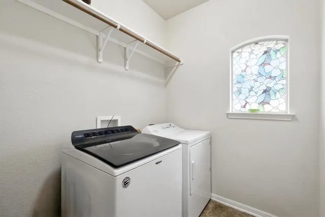 a utility room with a sink a vanity and wooden floor