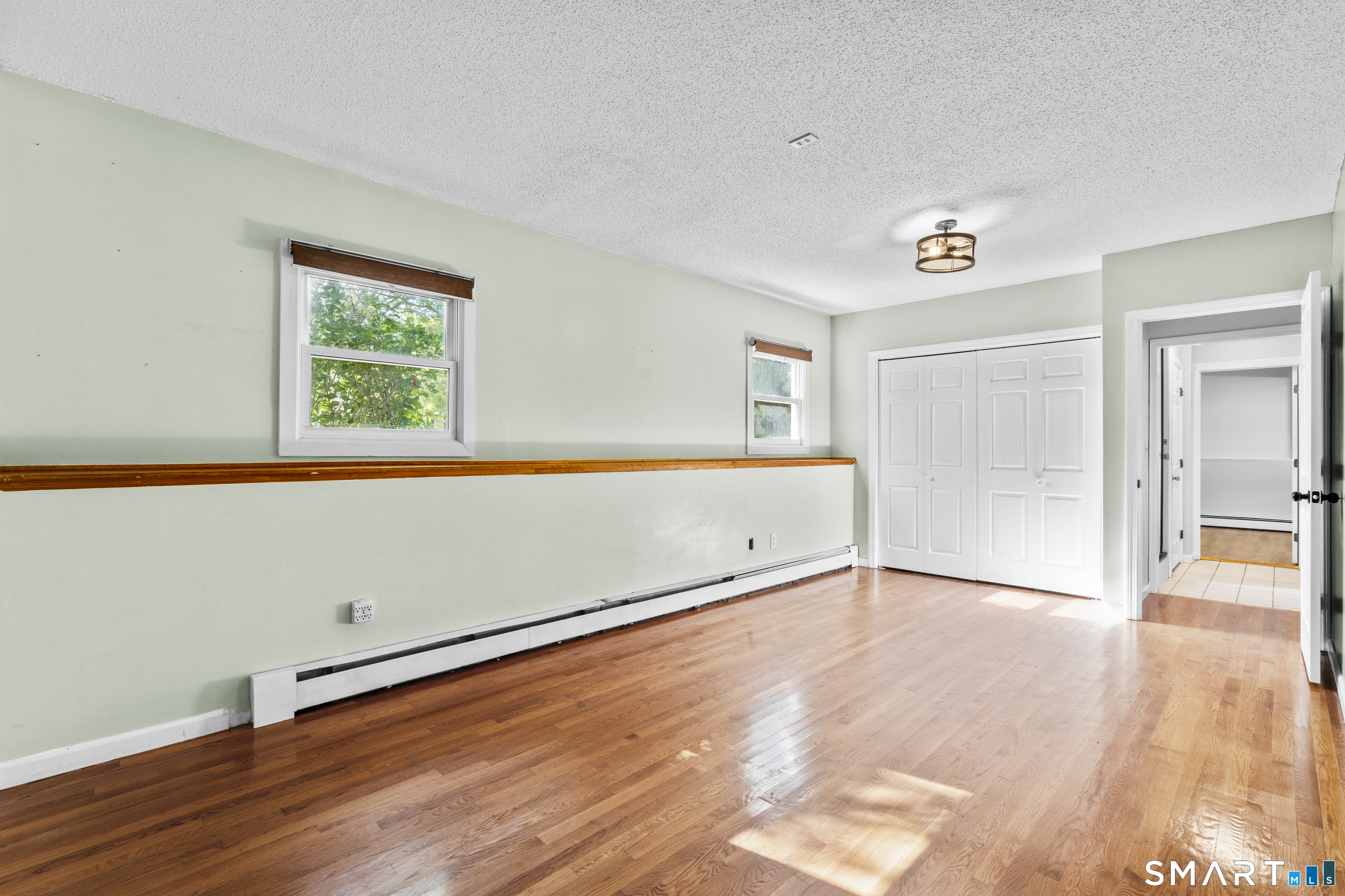 39 Joseph Lane Hamden, CT 06514 - Photo 35 of 40 an empty room with wooden floor and windows