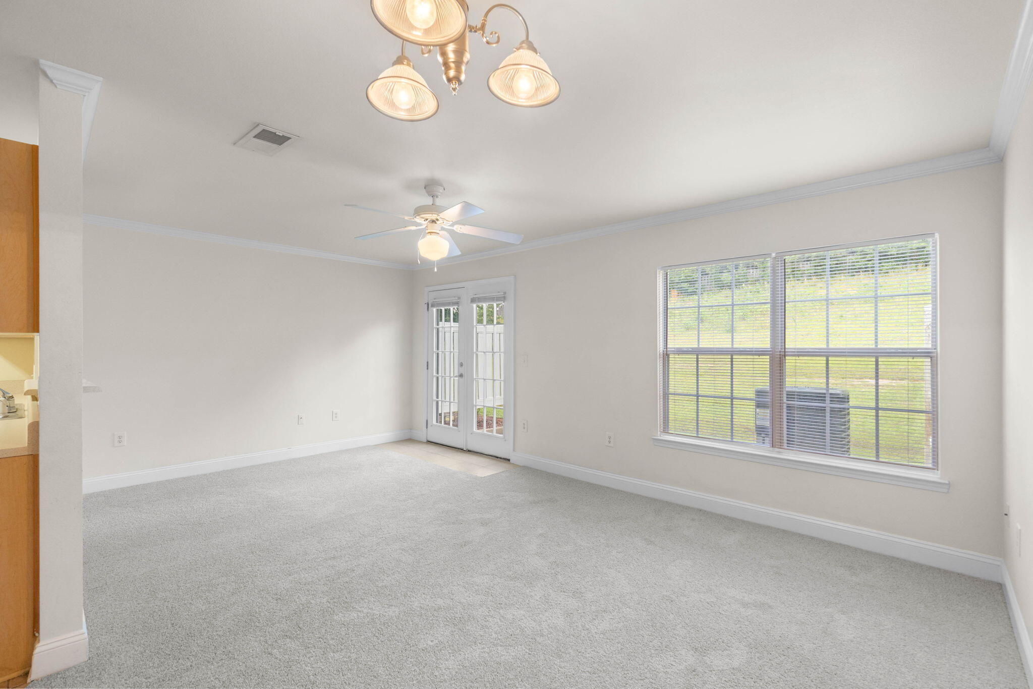554 Wingspan Way Crestview, FL 32536 - Photo 3 of 20 wooden floor in an empty room with a window